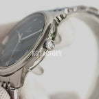 Omega wristwatch case and crown with dark dial and stainless steel bracelet