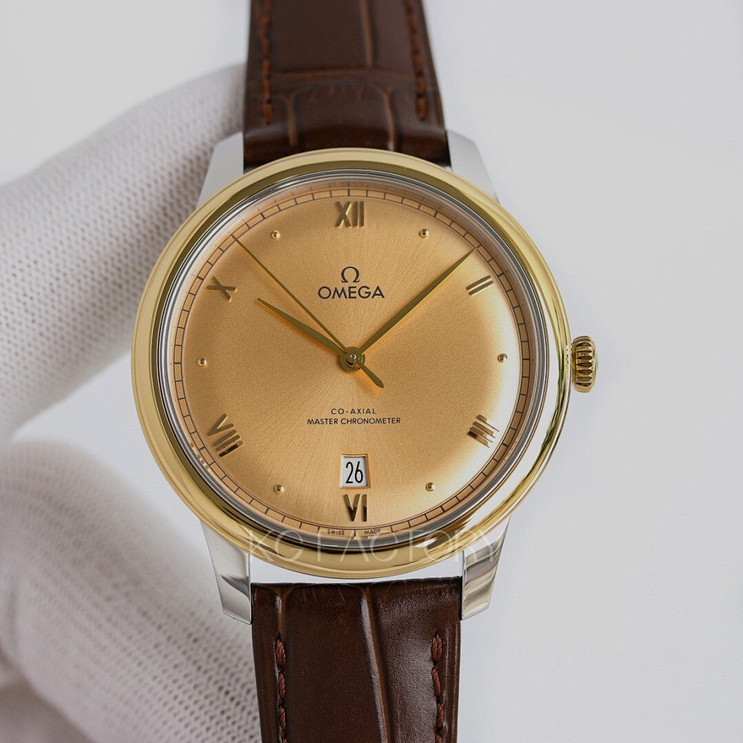 Omega watch with gold tone case, champagne dial, brown leather strap, roman numerals, date.