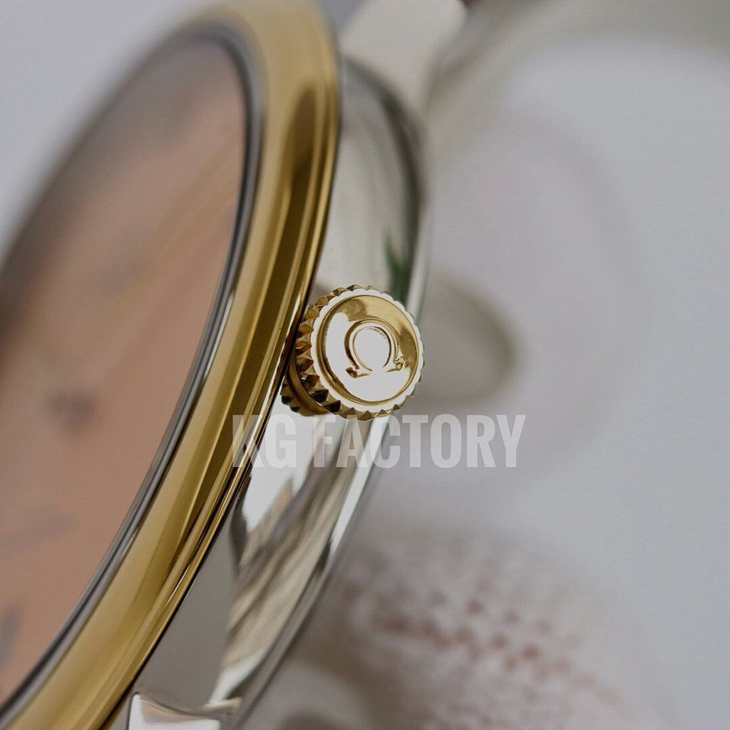 Gold-tone watch crown and case side on a metal wristwatch