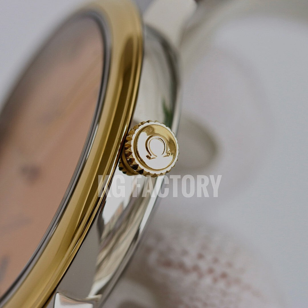 Gold-tone watch crown and case side on a metal wristwatch