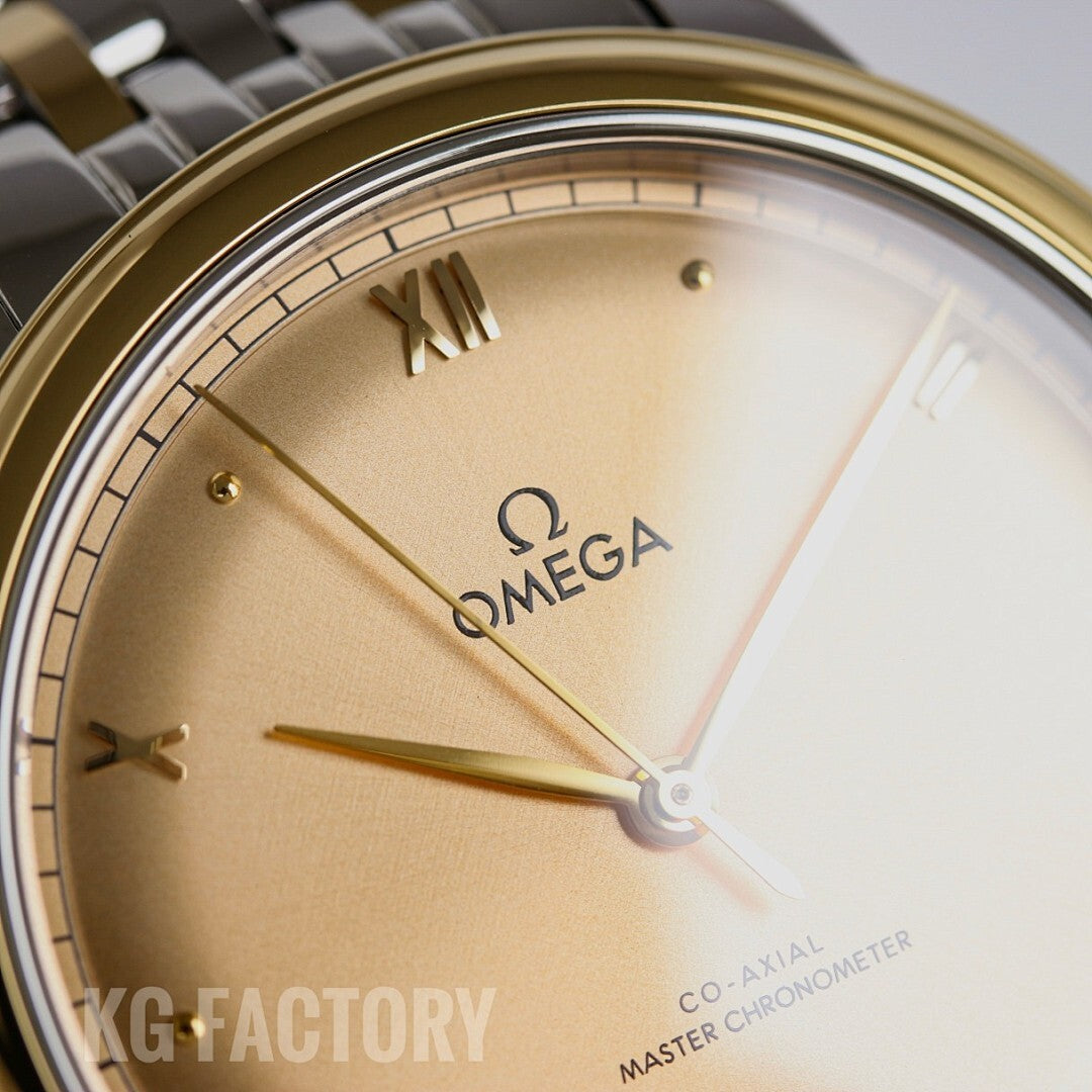 Close-up of champagne watch dial with gold Omega logo, Roman numerals, and hands