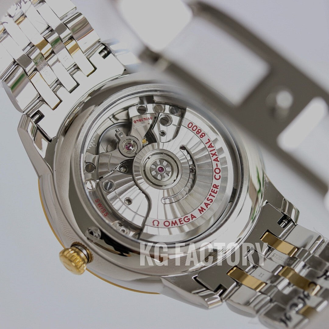 Two-tone wristwatch caseback with visible movement and gold accents