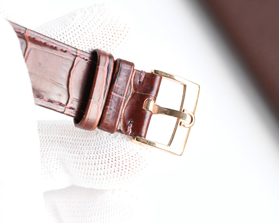 Omega watch brown leather strap with gold-tone buckle and keeper