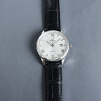 Wristwatch with white dial, Roman numerals, and black leather strap