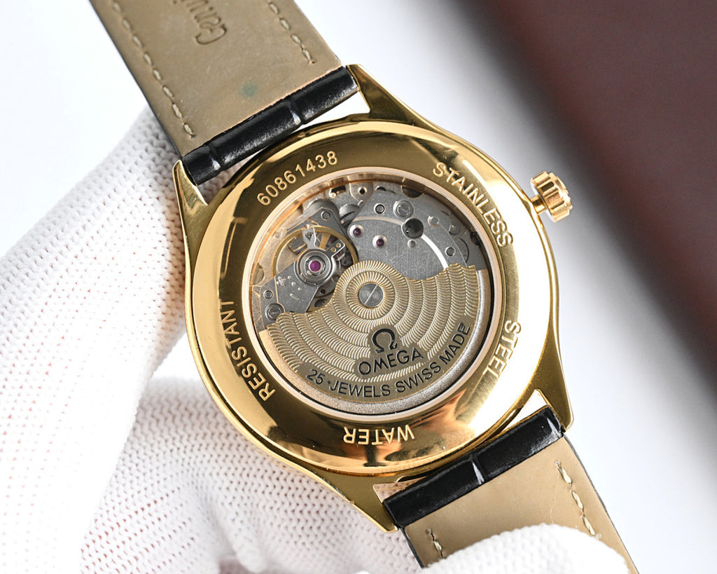 Omega watch caseback with engraved details, black leather strap and gold bezel