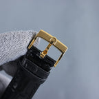 Black leather watch strap with gold buckle and keeper