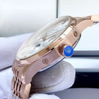 Omega watch rose-gold case side with crown detail and brushed metal finish.