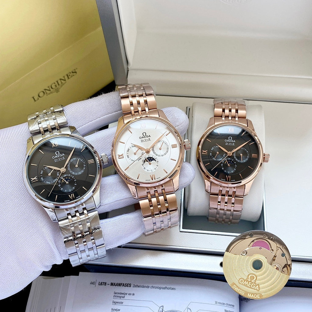 Omega watches in three colors on display trays, with bracelets and round dials.