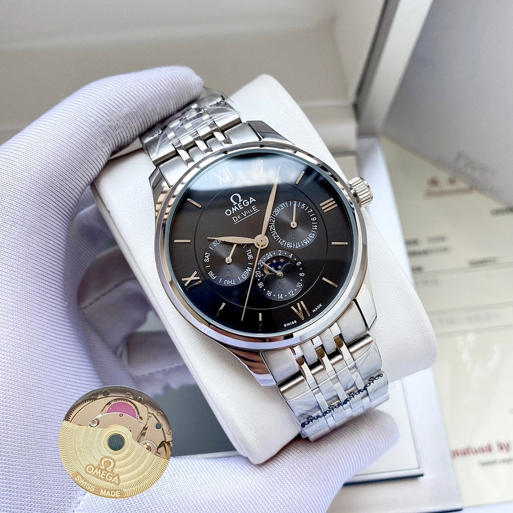 Omega watch with silver metal bracelet and dark blue dial on white display pillow.