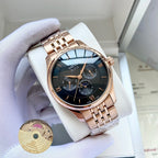Omega watch with rose-gold metal bracelet and dark blue dial on white display pillow.