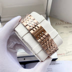 Omega watch rose-gold link bracelet on white watch pillow, side view of case.