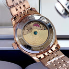 Omega watch caseback in rose-gold with engraved text and gold-toned internal detail.