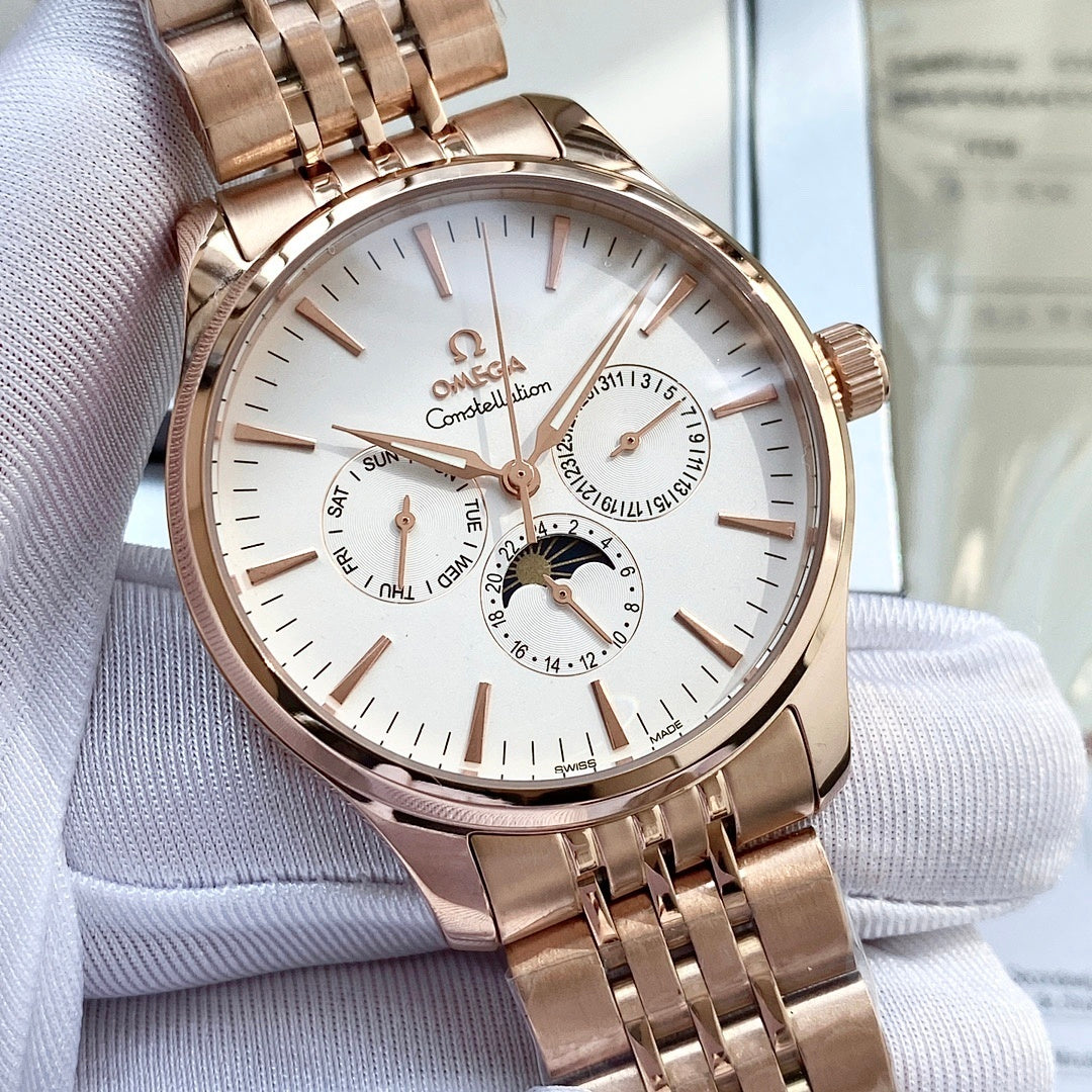 Rose-gold tone wristwatch with white dial, subdials, and metal link bracelet on display.