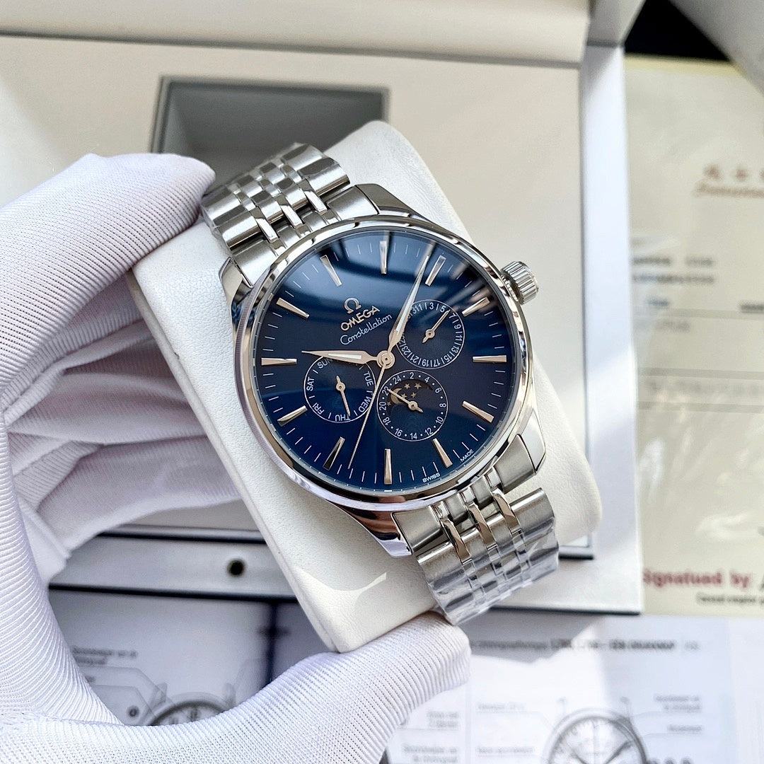 Silver-tone wristwatch with blue dial and metal link bracelet, shown in a gift box.