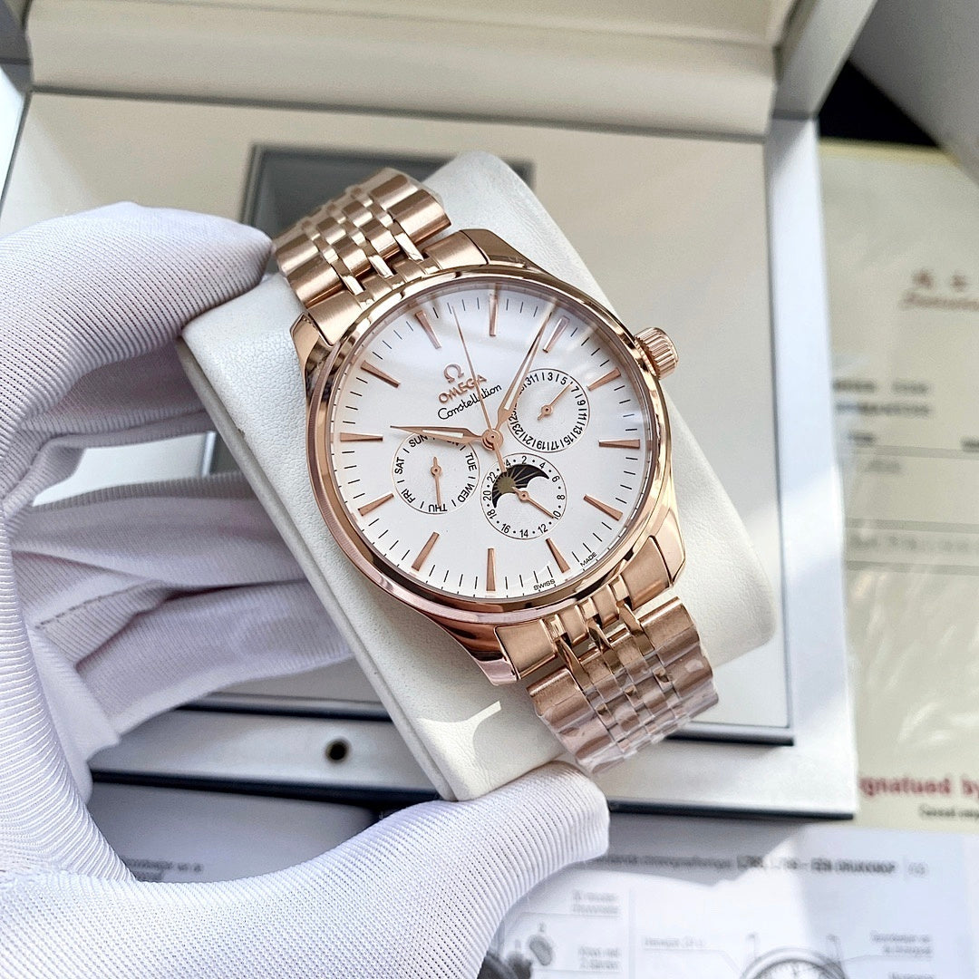 Rose-gold tone wristwatch with white dial and metal link bracelet resting on a box cushion.