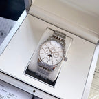 Omega watch with silver metal bracelet and white dial, displayed in open box