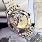 Omega watch case with open dial and mechanical details, silver metal bracelet