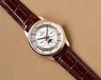 Omega watch front view with rose-gold case, white dial, brown leather strap