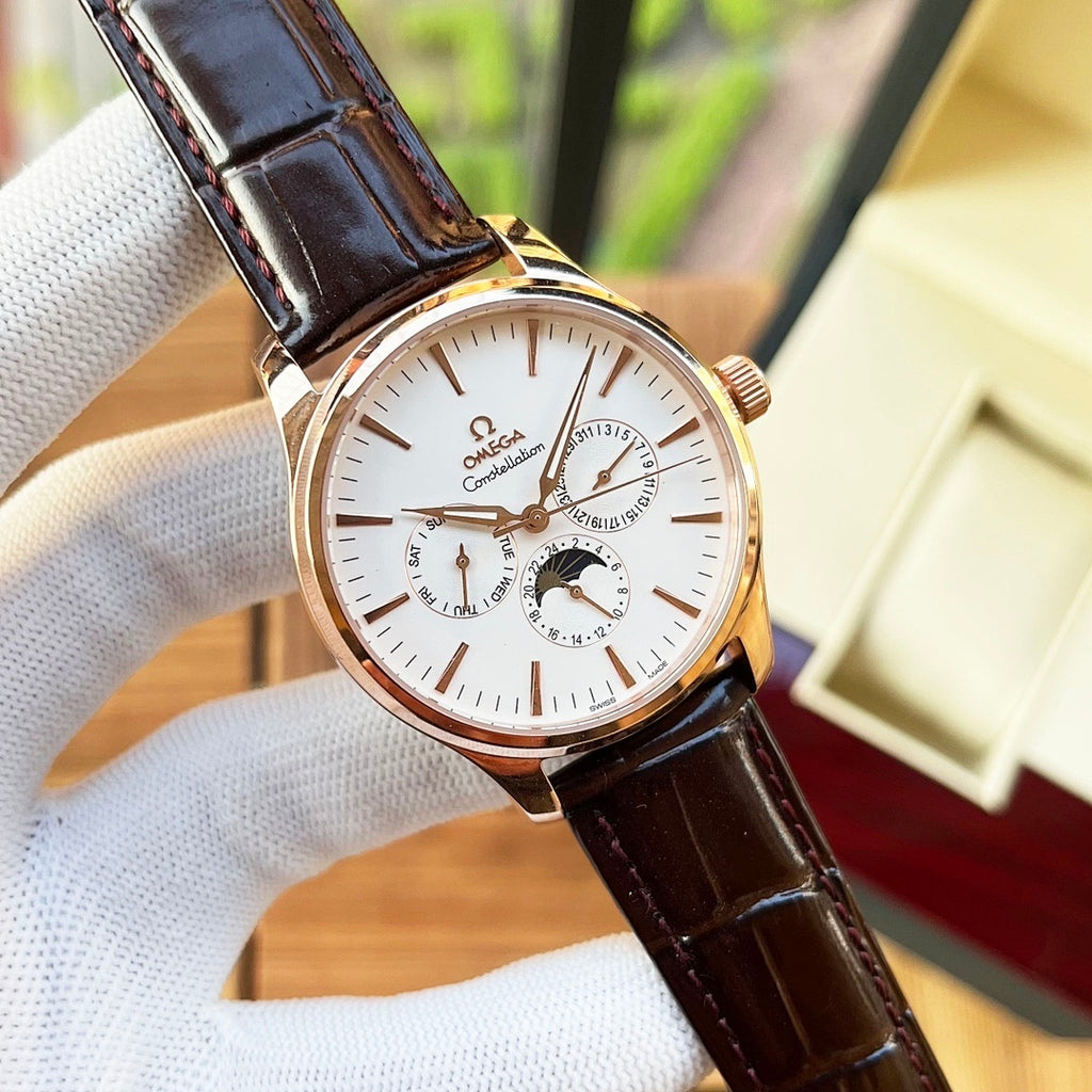 Omega watch with white dial and brown leather strap, gold-tone case and subdials