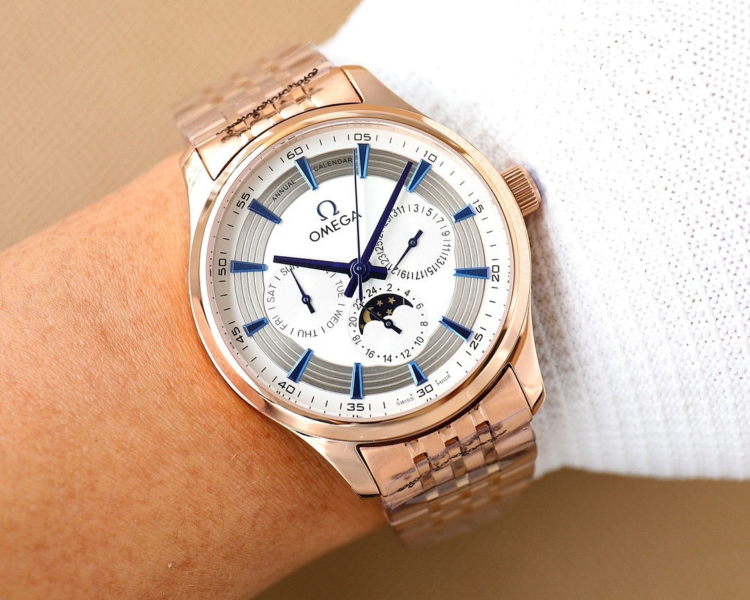 Rose gold Omega wristwatch with white dial, blue hands, and subdials on white cloth