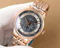 Rose gold Omega wristwatch with black dial and metal bracelet on white cloth