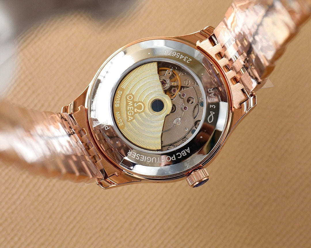 Rose gold Omega wristwatch with exposed movement on caseback, on white cloth