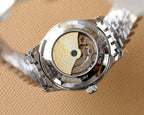 Omega watch caseback with visible mechanical movement in silver stainless housing