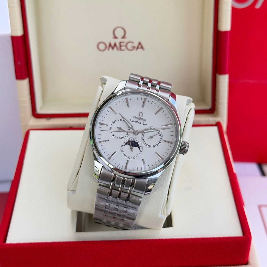 Close-up of silver-tone wristwatch with white dial and metal bracelet
