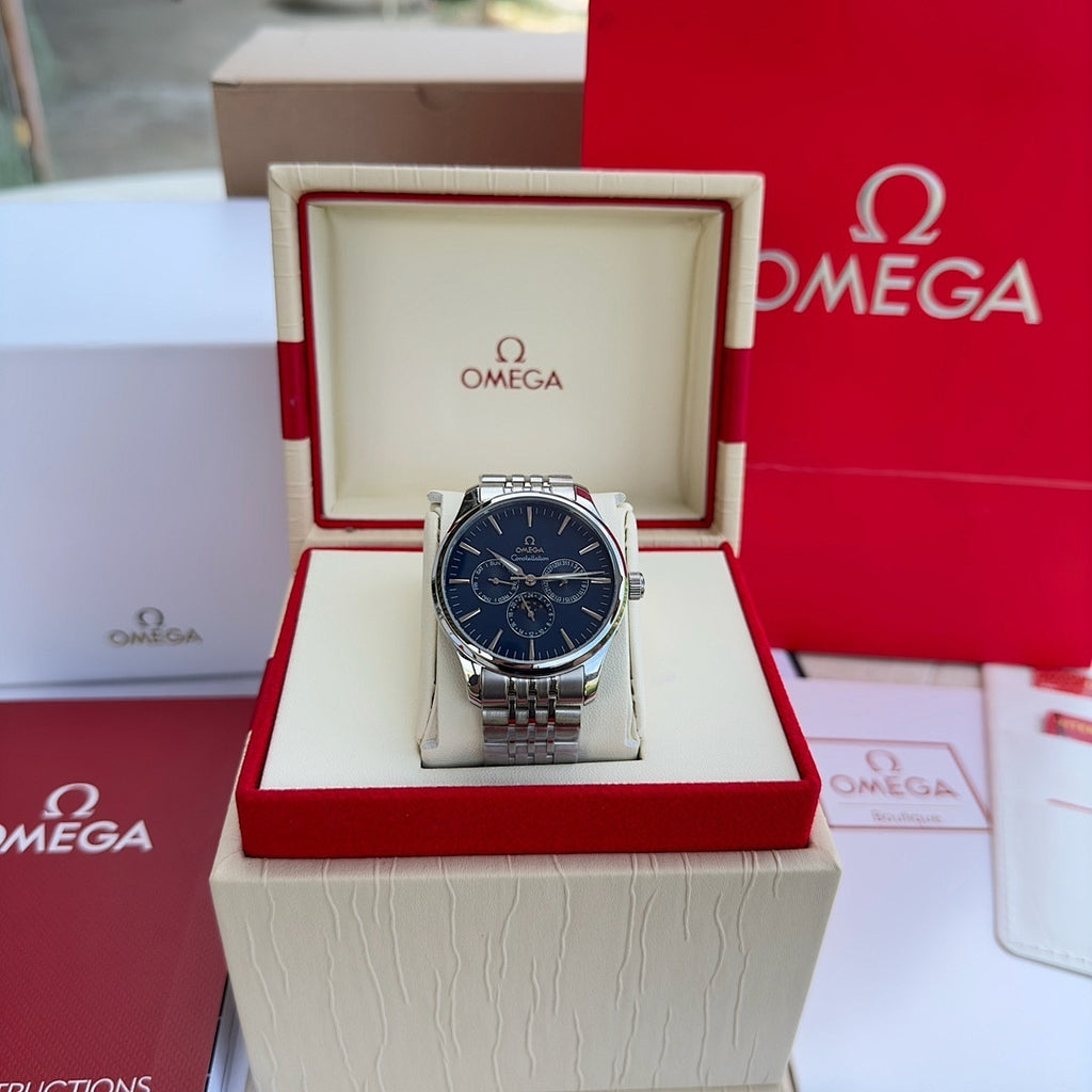 Silver-tone wristwatch with blue dial and metal link bracelet in display box