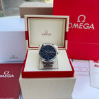 Silver-tone wristwatch with blue dial and metal link bracelet in display box