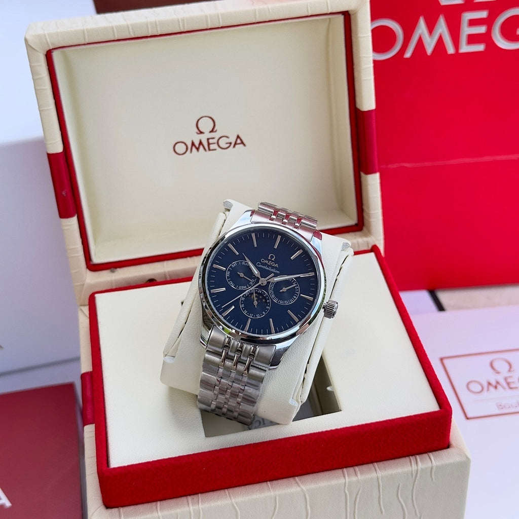 Silver-tone wristwatch with blue dial and metal link bracelet in display box