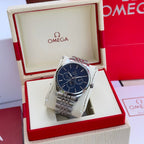 Silver-tone wristwatch with blue dial and metal link bracelet in display box
