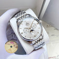 Omega wristwatch with silver-tone metal bracelet and white dial on a white pillow