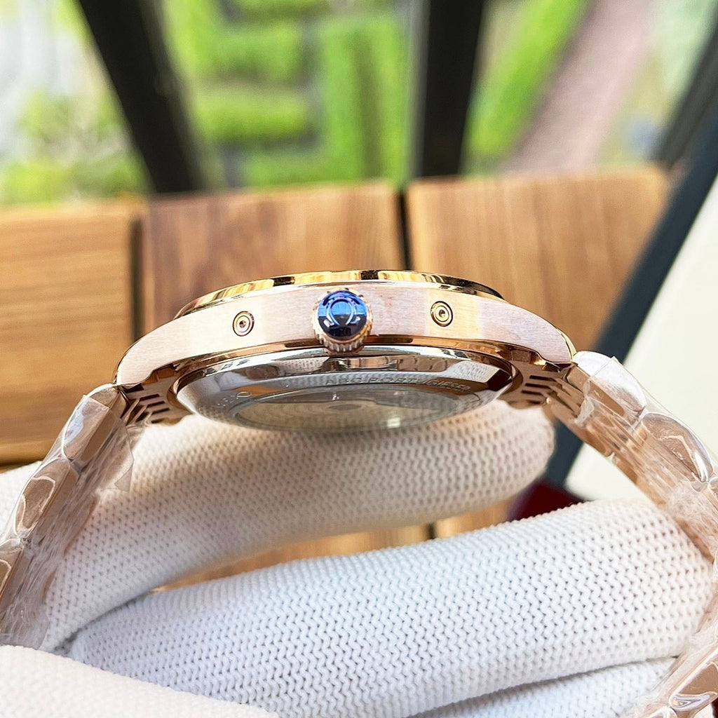 Omega wristwatch caseback with round crown and blue emblem