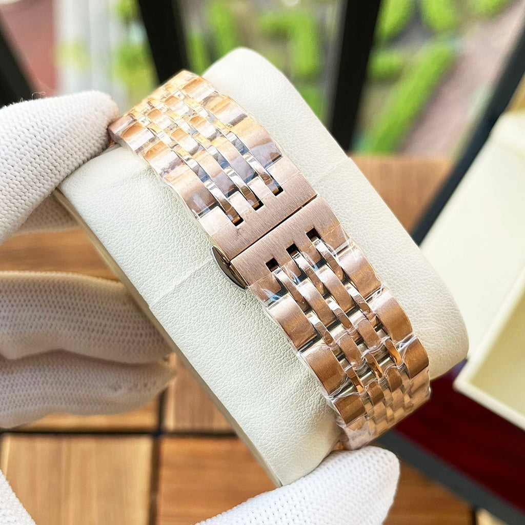 Omega wristwatch bracelet view with gold-tone metal links