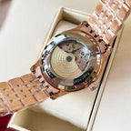 Omega wristwatch with rose-gold caseback and visible mechanical movement