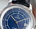 Blue dial automatic watch with silver bezel and black leather strap, date window