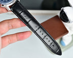 Black leather watch strap with stitched holes and polished buckle