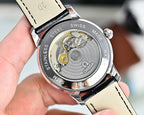 Stainless steel watch case back with visible automatic movement and black strap