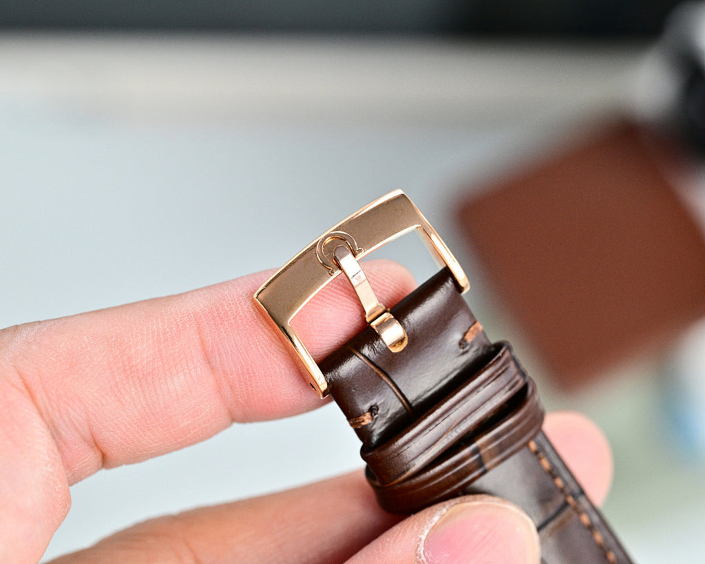 Leather watch strap with metal buckle clasp in rose-tone finish