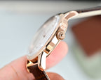 Rose-tone Omega wristwatch with crown detail and open side profile