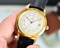 Gold Omega automatic wristwatch with black leather strap and white dial