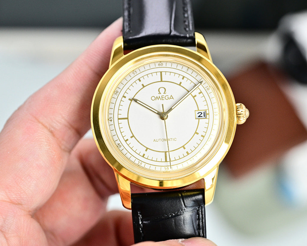 Gold Omega automatic wristwatch with black leather strap, white dial and date