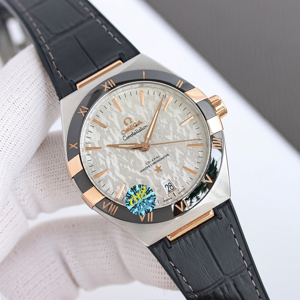 Omega wristwatch with silver dial, gold-tone bezel, black leather strap.