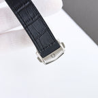 Omega wristwatch buckle with black leather strap and silver case back.