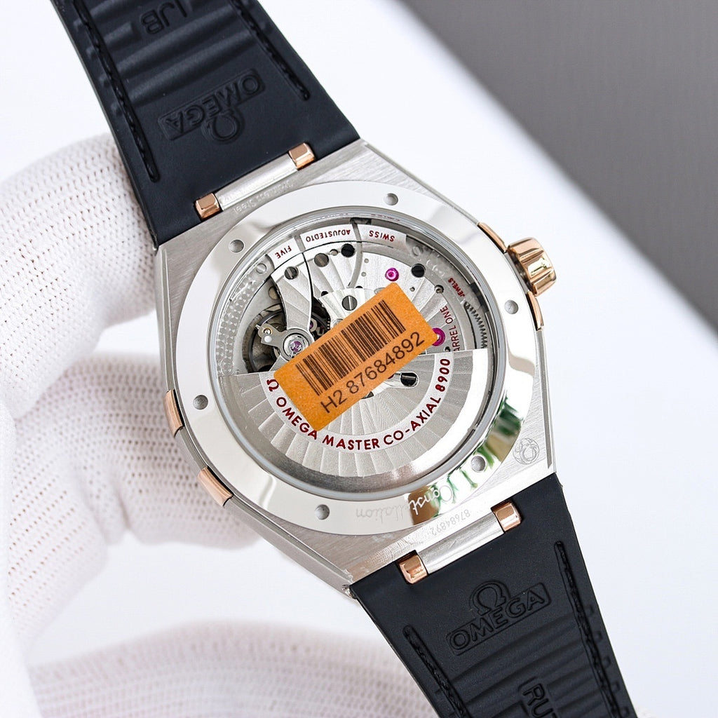 Omega wristwatch case back with exposed movement, black leather strap, gold-tone crown.
