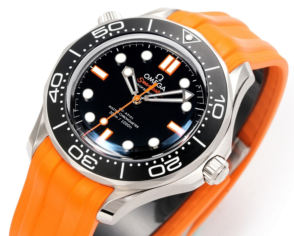 Omega diving watch close-up with black dial, orange hands and markers, orange silicone strap