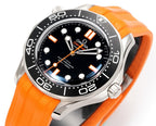Omega diving watch close-up with black dial, orange hands and markers, orange silicone strap