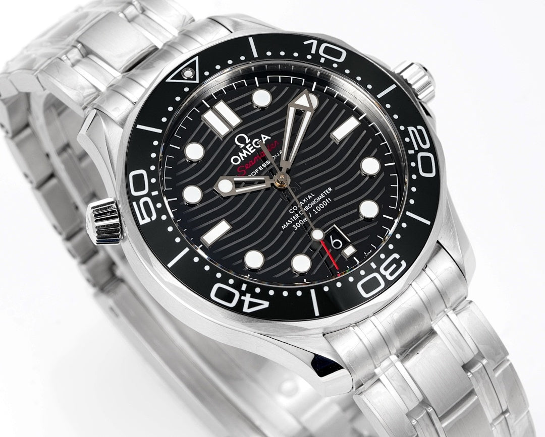 Omega dive watch close-up of black dial with markers, hands, and stainless steel bracelet