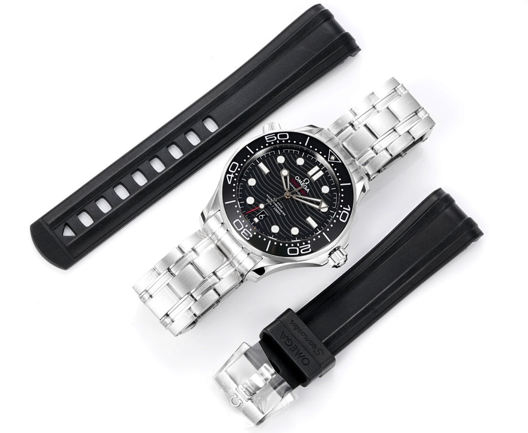 Diver watch shown with black rubber strap and stainless steel case over bracelet links